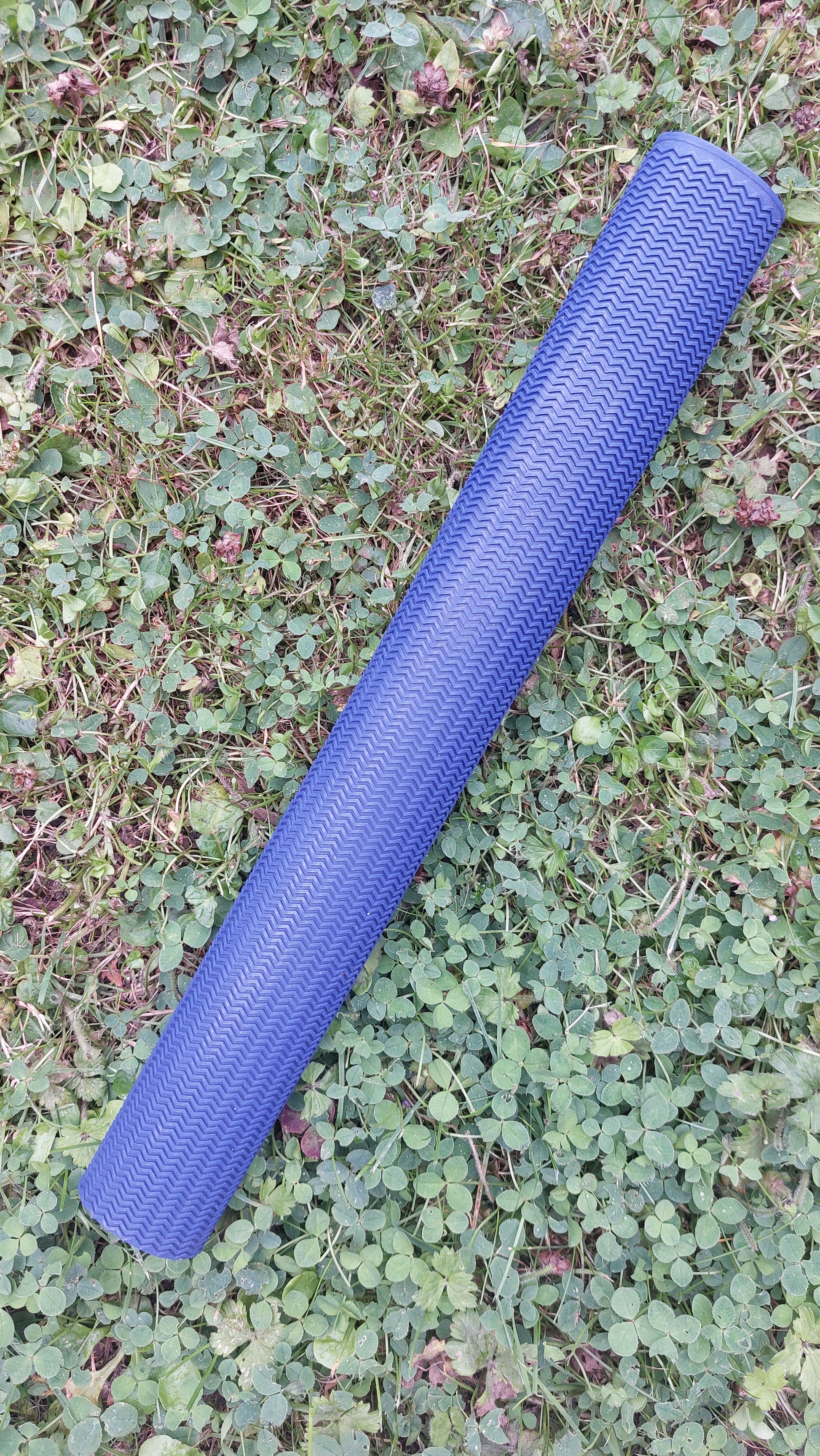WC Cricket blue chevron cricket bat grip replacement roll for cricket bat restoration showing textured pattern on grass
