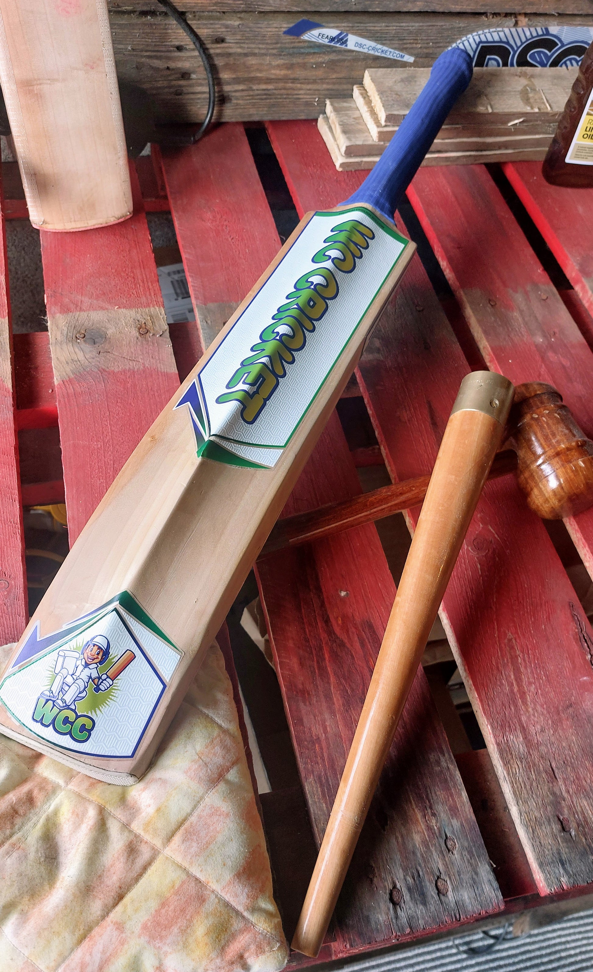 WC branded cricket bat, cricket bat mallet and grip cone