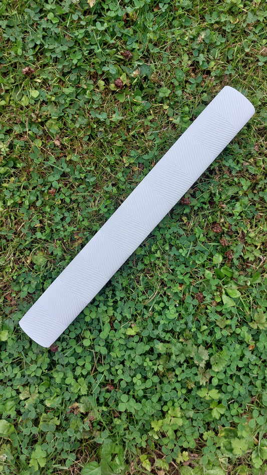 WC Cricket white chevron cricket bat grips roll on grass showing textured white replacement grip for bats